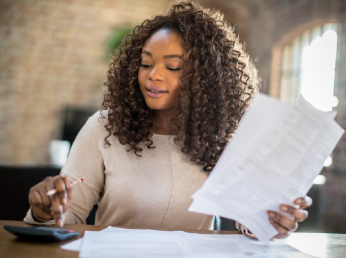 Woman with Calculator and Paper
